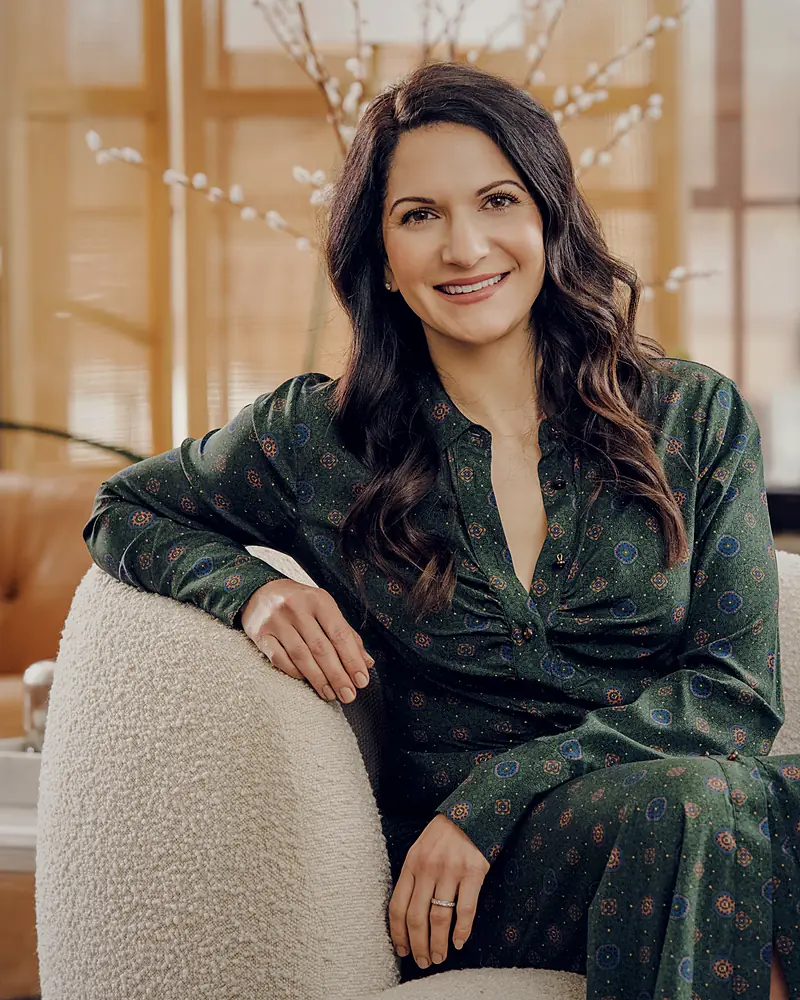 Me, Amy Buchan Siegfried, seated in an armchair, smiling toward the camera